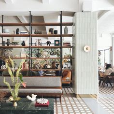 a living room filled with furniture and lots of shelves