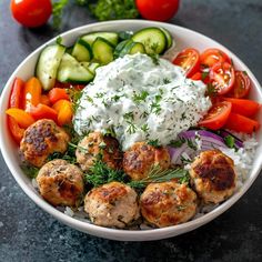 a white bowl filled with meatballs and vegetables