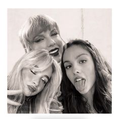 three women with their mouths open posing for the camera