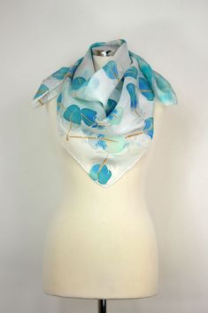 Size: approx. 86 x 86 cm. One-of-a-kind hand-painted silk scarf featuring a whimsical yet subtle design of simple feathers. Large square hand-painted silk scarf hand-dyed and hand-painted in neutral shades of turquoise blue and vibrant navy blue painted on each feather made of luxury habotai silk fabric. This is a classic silk square scarf. First, I hand-dyed the background and then paint the ends to achieve a dramatic and intricate look. I chose my trademark feathers of Heron and used feminine, Elegant Hand Painted Blue Silk Scarf, Hand Painted Blue Silk Scarf For Gift, Blue Silk Scarf As Summer Gift, Blue Silk Scarf For Summer, Blue Silk Scarf For Summer Gift, Artsy Blue Silk Scarf As Gift, Artsy Blue Silk Scarf Gift, Artsy Blue Scarf As A Gift, Artsy Blue Scarf As Gift