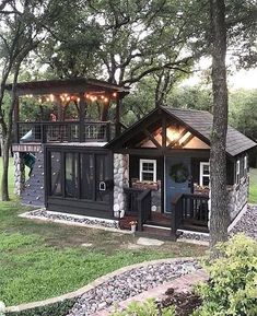 a small house with lights on the roof and windows in it's front yard