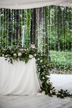 a table with flowers and greenery on it