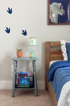 a bed room with a neatly made bed and a night stand next to the bed