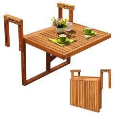 a wooden table with two chairs and plates on it next to a potted plant