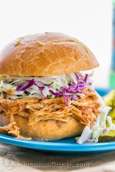 a pulled pork sandwich with coleslaw and slaw