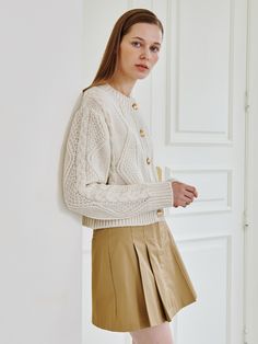 Editor's NotesThis cable-knit cardigan is made of a voluminous woolen material. It is distinguished by the use of high-quality gold buttons that capture the spirit of Nouve, exuding formal mood.- Versatile piece with a moderate thickness that can be worn alone or under an outer layer- Relaxed fit and moderately cropped length that can be paired with a variety of items- Knit design pattern that exudes distinctive and unique mood* Please consider that the actual color may differ slightly due Wool Cable Knit Cardigan For Work, Cream Cable Knit Cardigan For Work, Cable Knit Button-up Workwear Sweater, Button-up Cable Knit Sweater For Work, Beige Cable Knit Button-up Sweater, Cable Knit Cardigan, Wool Knit, Gold Buttons, Knitting Designs