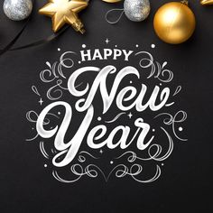 new year's greeting card with gold and silver ornaments on a black background that says happy new year