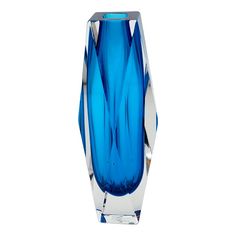 a blue glass vase sitting on top of a table