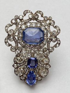 Handmade item  Recycling: No Brooch weight: 28.300 Grams Brooch Length: 3.50 Inches  Brooch Width: 2.00 Inches  Gemstones: American Diamonds [zircon] & Blue Sapphire  Diamonds weight: 16.11 Carats Diamonds Shape: Round  Diamonds Colure: white   Diamonds putting: Prong  Material: Silver  Silver purity: 925 Blue Sapphire weight: 45.78 Carats  Blue Sapphire: Lab Created  Brooch Finished: Antique & Gold Biedermeier Furniture, Edwardian Jewelry, Gem Diamonds, Blue Sapphire Diamond, Diamond Brooch, Royal Jewelry, Sapphire Necklace, Victorian Jewelry, Emerald Jewelry