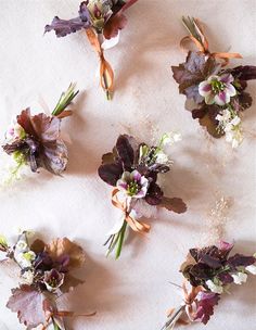 the flowers are arranged in rows on the tablecloth, which is covered with white and purple fabric