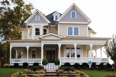 a large white house sitting on top of a lush green field