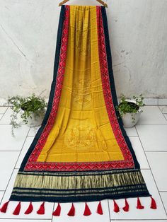 Fabric: Semi Gajji Silk Detailing: Zari Border, Patola Print Length: 2.5 meter Yellow Dupatta With Bandhani Print And Traditional Drape, Yellow Bandhani Print Dupatta In Traditional Drape, Yellow Bohemian Dupatta With Bandhani Print, Bohemian Yellow Saree With Printed Border, Yellow Traditional Wear With Printed Border, Traditional Yellow Wear With Printed Border, Yellow Dupatta With Border For Navratri, Yellow Border Dupatta For Navratri, Festive Yellow Dupatta With Printed Border