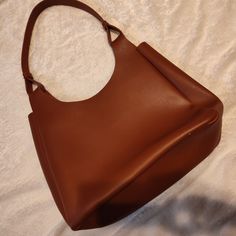 This Is A Beautiful Genuine Leather Tote Bag New Without Tags , Brand Is Neiman Marcus In A Brown Camel Color It Has A Small Flaw As Shown On Last Image This Purse Is Valued At @$220 . Large Capacity Tan Shoulder Bag For Office, Classic Tan Shoulder Bag With Large Capacity, Large Capacity Tan Leather Shoulder Bag, Classic Faux Leather Hobo Tote Bag, Elegant Tan Hobo Bag For Daily Use, Faux Leather Hobo Bag For Shopping, Chic Tan Shoulder Bag For Everyday, Elegant Shopping Hobo Bag In Faux Leather, Elegant Tan Hobo Bag For Everyday Use