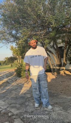 a man standing in front of a tree with his face painted like a human head