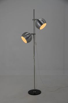 two light floor lamp on black base with dimmers in the middle and white background