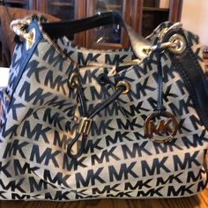 Medium Sized, Drawstring Carry All Bag With Michael Kors Logo Printed On Fabric With Leather Detailing And Gold Hardware For A Beautiful Luxe Look. Can Pair Easily As Casual Or Dressed Up And Compliments Any Look. Brand New Without The Original Tag But Never Been Used. Multiple Zipper Pockets On Inside As Well As Pockets On The Outer. Drawstring Cinch And Snap Closures. Very Roomy Without Being Bulky! There’s A Slight Part Of The Leather That’s Worn Off On One Side, I Will Update W Pictures Soon Casual Michael Kors Shoulder Bag With Double Handle, Michael Kors Hobo Shoulder Bag For Travel, Michael Kors Casual Bags With Branded Hardware, Casual Michael Kors Tote Shoulder Bag, Casual Michael Kors Shoulder Bag For Errands, Michael Kors Casual Shoulder Bag, Casual Michael Kors Shoulder Bag, Michael Kors Casual Shoulder Bag With Adjustable Strap, Casual Michael Kors Shoulder Bag With Adjustable Strap