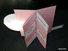 an open pink card with white paper on it