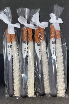 four toothbrushes wrapped in plastic with bows