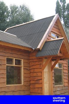 a small wooden cabin with a metal roof