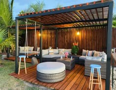 an outdoor living area with couches and chairs