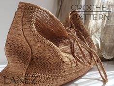 a crocheted bag sitting on top of a bed