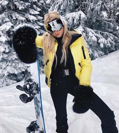 a woman standing on top of a snow covered slope