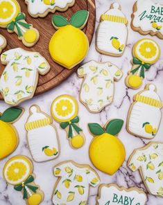 baby shower cookies decorated with lemons and white icing on a marble countertop