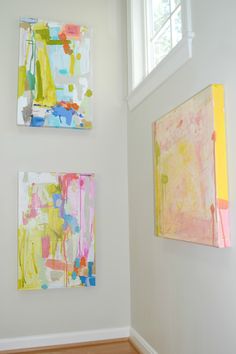 three paintings hang on the wall next to each other