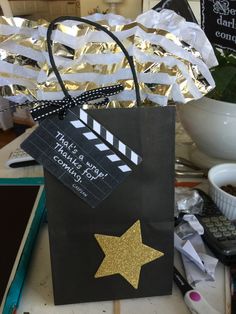 a black bag with a gold star on it and a movie clapper attached to it