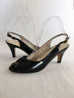 "Classic looking peep toe slingback heels by Salvatore Ferragamo! Done up in black leather with a black bow perched on the cut out, they will be sure to complement a vintage or modern look! Sold through Saks Fifth Avenue. Marked US 8 AAAA Heel: 3.25\" Length: 9.5\"  Ball: 2.75\"" Formal Heels With Bow Straps And Round Toe, Chic Open Toe Slingback Pumps With Bow, Black High Heel Slingback Pumps With Bow Straps, Leather Slingback Pumps With Bow For Evening, Leather Sandals With Bow Straps For Formal Occasions, Evening Leather Slingback Pumps With Bow, Black Bow Slingback Pumps For Evening, Formal Leather Sandals With Bow Straps, Black Open Toe Heels With Bow