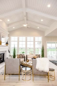 a living room filled with furniture and a fire place in the middle of a room