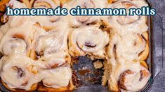 homemade cinnamon rolls with icing in a baking pan on a counter top and the words homemade cinnamon rolls above it