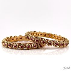 Size:2.4 Liven up any look with these stunning flower patterned bangles in a rajwadi finish. Studded with red stones, the intricate design and unique matte finish will make heads turn. These bangles open wide so you can easily slip them on and off. Perfect for any fashionista's wardrobe. Traditional Red Filigree Jewelry, Red 22k Gold Jewelry With Intricate Design, Traditional Ruby Bangle For Festive Occasions, Traditional Red Bracelet With Stone Work, Traditional Red Stone Work Bracelet, Elegant Red Tilla Bangle, Red Stone Work Bangle Jewelry, Red Bracelets With Intricate Design For Festive Occasion, Traditional Ruby Bracelets With Jeweled Detail