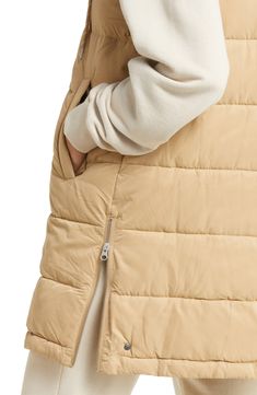 Add an extra layer of warmth to your wardrobe with this water-resistant puffer vest in a longline silhouette designed to keep your core cozy on cool-weather days. 33 1/2" length (size Medium) Front zip closure with snap storm flap Drawstring hood Front welt pockets Side zip vents Lined, with 100% polyester fill 100% polyester Machine wash, tumble dry Imported Women's Active & Swim Hooded Puffer Vest, Swimming Activities, Weather Day, Active Women, Puffer Vest, Silhouette Design, Long A Line, Welt Pocket, Welt Pockets