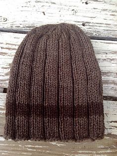 a brown knitted hat sitting on top of a wooden floor