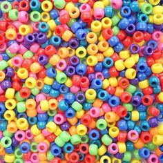 multicolored plastic beads are shown in this image