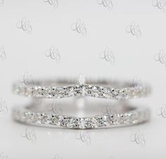 two white gold wedding bands with round diamonds on each band, set in 18k white gold