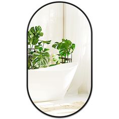 there is a mirror with plants in it