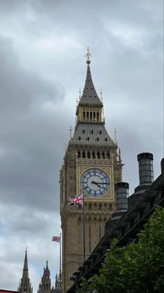 the big ben clock tower towering over the city of london on a cloudy day in england