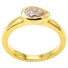 This stunning and classic diamond ring is set in 18K yellow gold and the diamond size is approx. 0.62 carats. The side setting of the tear drop diamond is elegant and artistic as it sings of individuality and is made to perfection in a traditional bezel setting. The band is thick and substantial. Great for stacking and brilliant by itself. Color I, Clarity SI2. The ring is a size 6 1/4 and can be sized to fit your finger. Teardrop Diamond Ring With Single Diamond For Anniversary, Gold Pear-shaped Single Diamond Ring, Gold Pear-shaped Diamond Ring With Single Diamond, Gold Pear-shaped Diamond Ring, Yellow Gold Teardrop Diamond Ring With Rose Cut Diamonds, Teardrop Rose Cut Diamond Ring In Yellow Gold, Teardrop Single Diamond Ring, Gold Teardrop Diamond Ring With Single Diamond, Classic Pear-shaped Diamond Ring With Rose Cut Diamonds