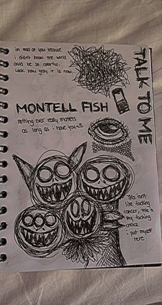 a notebook with some drawings on it and an image of monster faces in the background