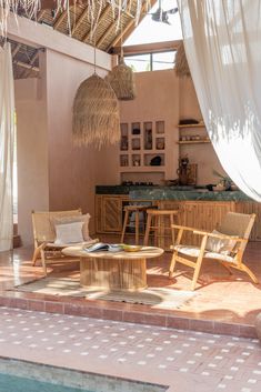 an outdoor living area with wicker furniture