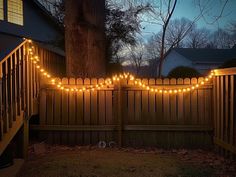 a fence with lights strung across it