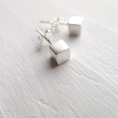 These earrings are perfectly petite and perfectly precious for every day wear. They are feature sterling silver brushed cubes on sterling silver posts. Sterling silver ear nuts are included. . { m e a s u r e m e n t s } . ~4mm each side . { o p t i o n s } . Other Post Earring Styles: https://www.etsy.com/shop/CamileeDesigns?section_id=10245147&ref=shopsection_leftnav_3 . { p a c k a g i n g } . Your jewelry will arrive in a cute snap box - perfect for giving or keeping for yourself. . { s Sterling Silver Simple Design Earrings For Gift, Simple Sterling Silver Earrings As Gift, Simple Small Silver Earrings, Tiny Modern Earrings For Gift, Modern Tiny Earrings For Gift, Tiny Minimalist Sterling Silver Earrings, Minimalist Silver Earrings For Gift, Minimalist Hypoallergenic Earrings For Gift, Geometric Earrings Studs