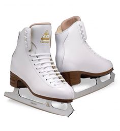 a pair of white ice skates sitting on top of each other