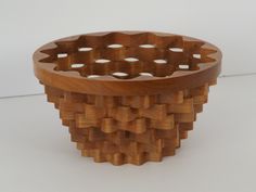 a wooden basket with holes in the middle