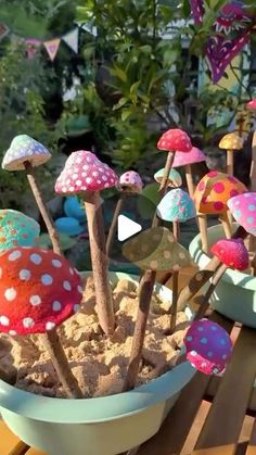 there are many colorful mushrooms in the bowl on the table and one is made out of clay