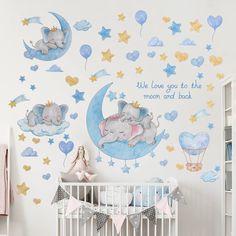 a baby's room with an elephant and moon wall decal