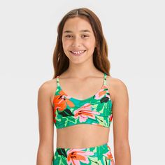 Help your kid create a fresh garden look for beach or pool fun by wearing the "Sun Seeker" Floral Printed Bikini Swim Top from art class™. Covered with dainty floral print, this sleeveless swim top features cinches at the center. This pullover-style top is made from a soft fabric with spandex that offers four-way stretch, and adjustable straps for comfortable wear. It's designed with removable cups for customized coverage, and helps keep them protected from the sun with the UPF 50+ rated fabric. Playful Green Swimwear With Uv Protection, Green Swimwear For Summer Beach Activities, Summer Beach Tankini, Playful Green Swimwear For Summer Activities, Spring Beachwear Swimwear For Play, Green Swimwear For Summer Activities, Playful Tankini For Spring Sunbathing, Playful Green Printed Swimwear, Green Printed Swimwear For Play