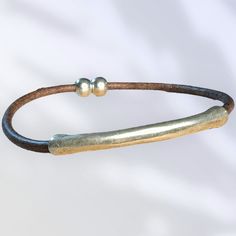 Made to Order! Simple 3mm round leather cord with silver tube charm with Zamak magnetic closure. Zamak is a family of alloys with a base metal of zinc and alloying elements of aluminium, magnesium, and copper and is Hypoallergenic Magnetic Closure, Round Leather, Base Metal, Leather Cord, Leather Bracelet, Magnets, Copper, Charm Bracelet, Band